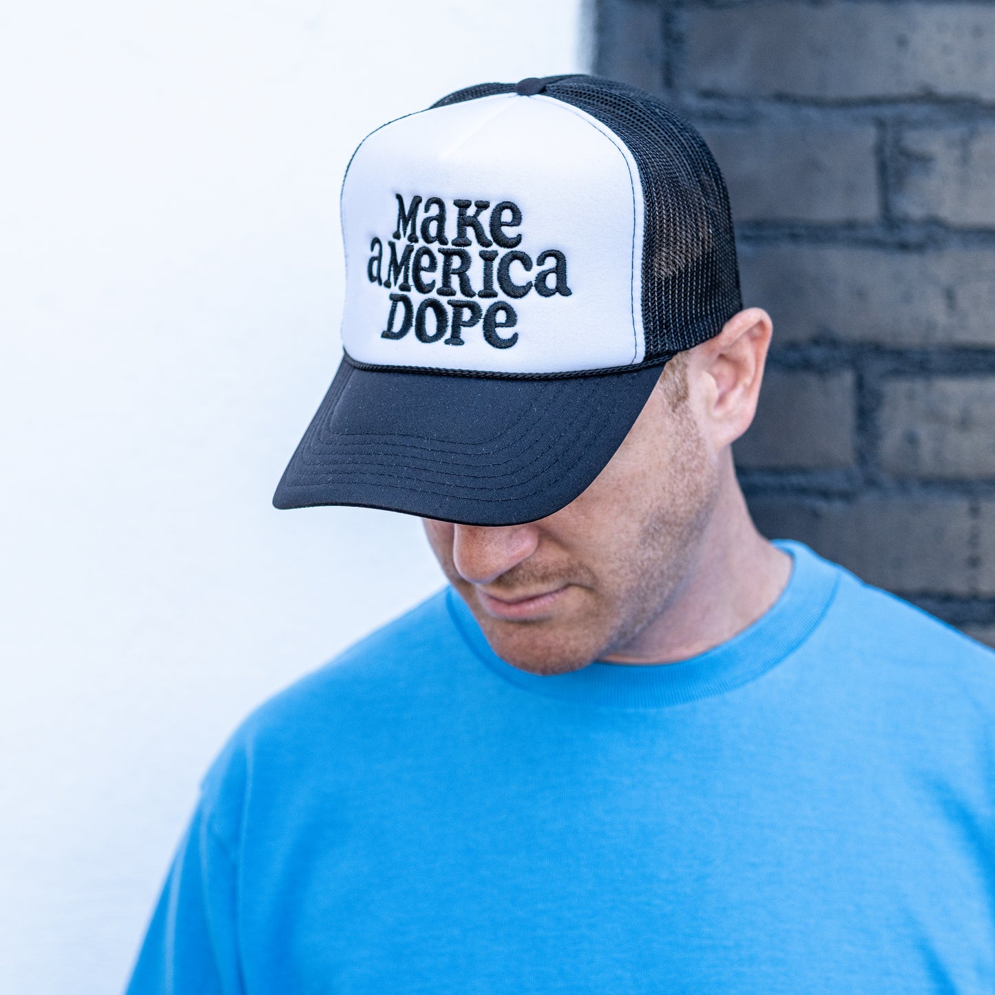 Man wearing black and white Make America Dope Hat 